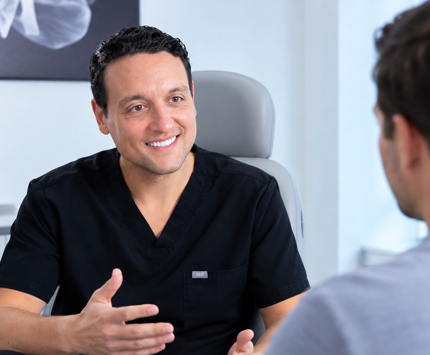 Dr. David Shokrian discussing recovery after penile enhancement surgery with a patient