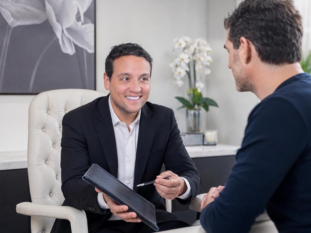Dr. David Shokrian discussing hyaluronic acid penile filler options with a patient during a private NYC consultation
